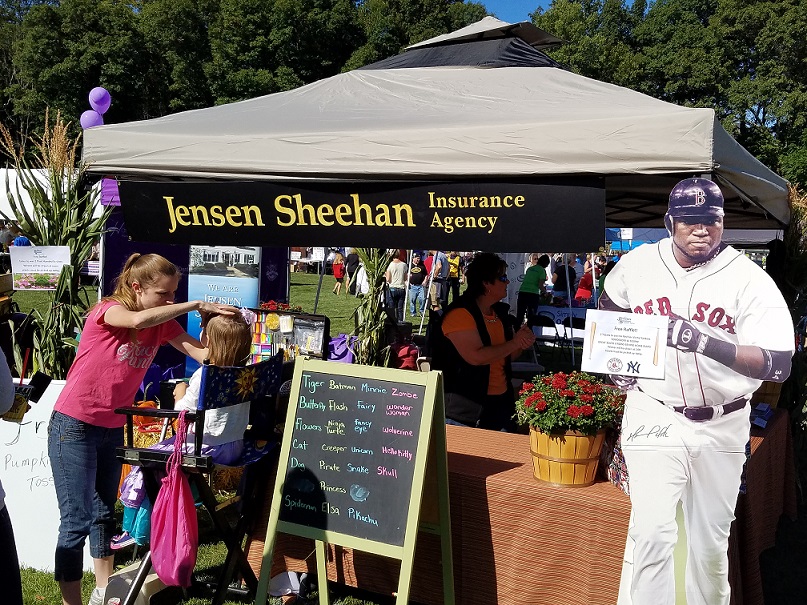 face painter painting in front of Jensen Sheehan table