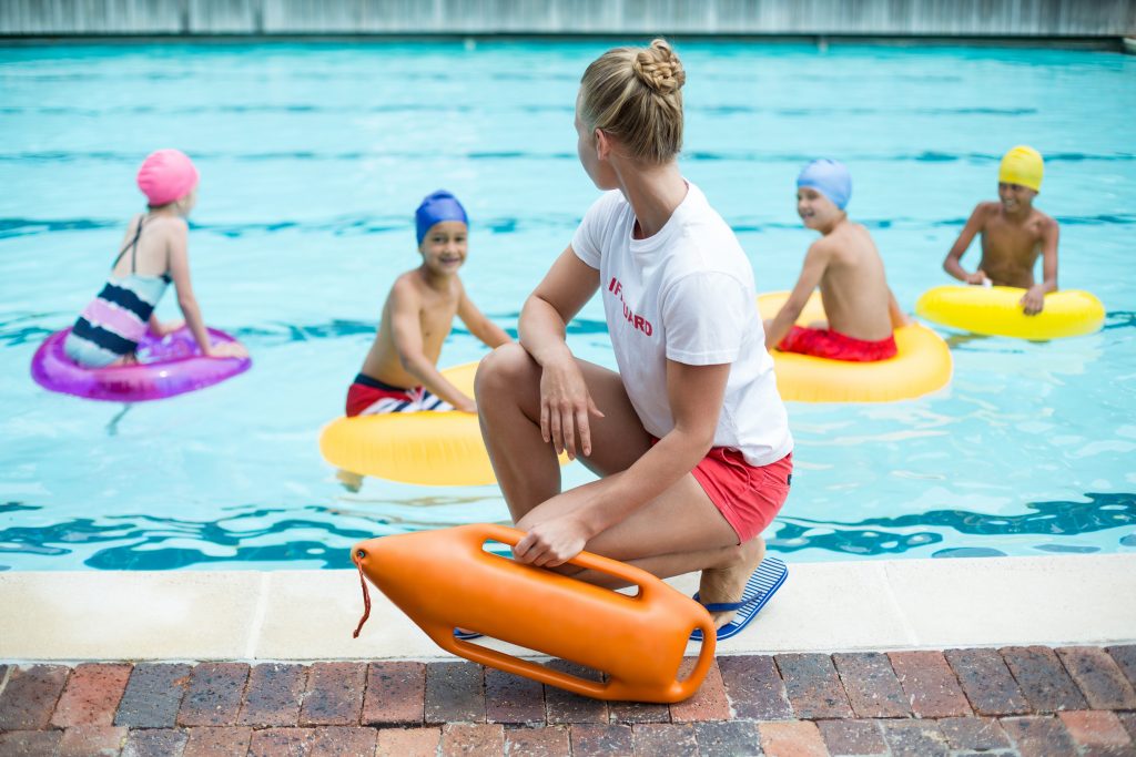 Lifeguard watching over kids in a pool