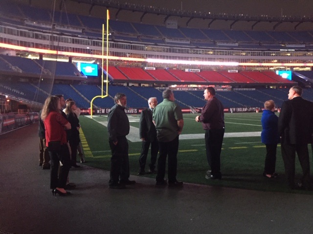 Employees standing near the football field