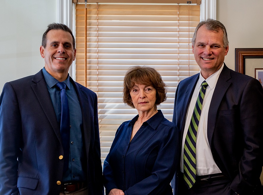 President Steve Ellis standing with sales people Joe and Sandra